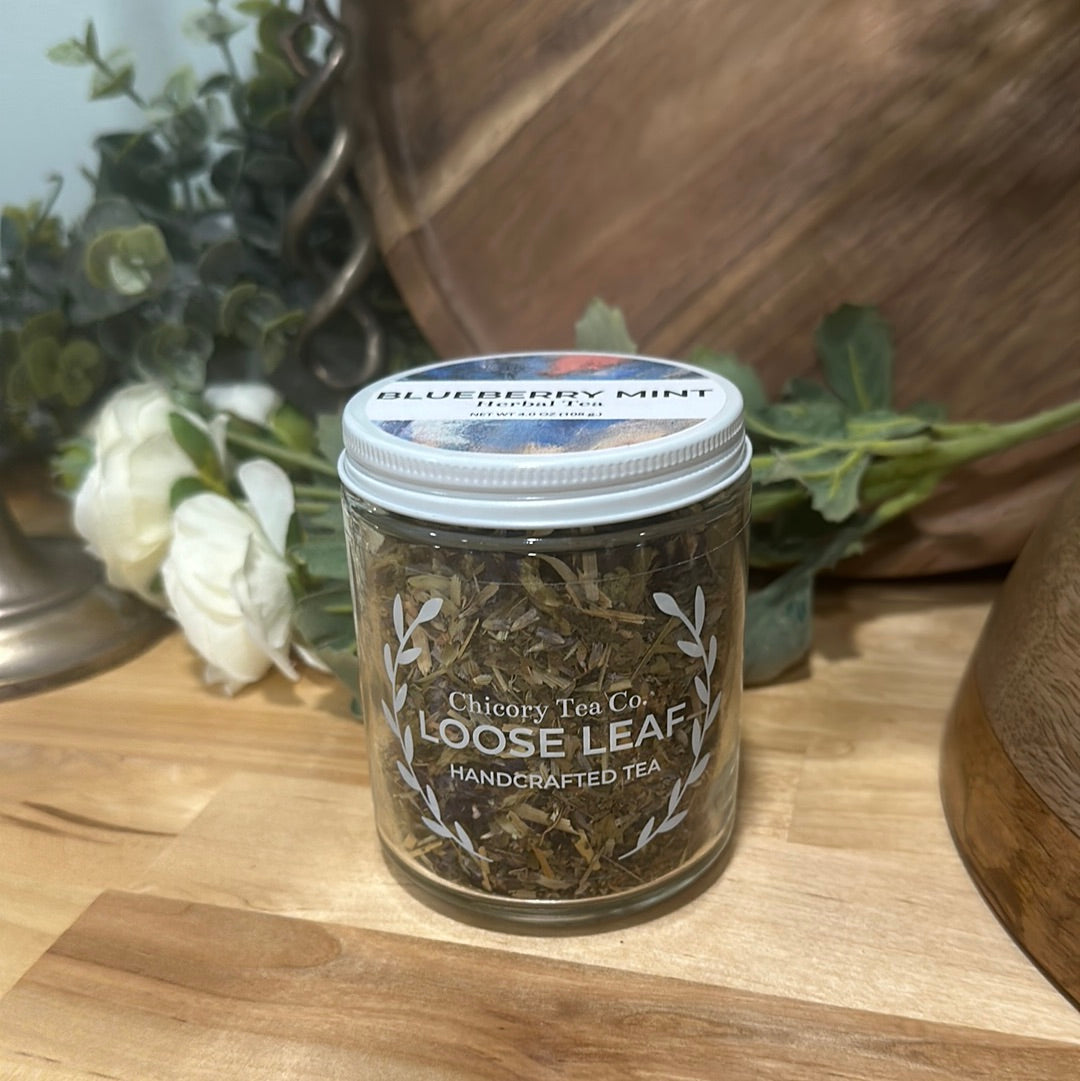 An artistic product photo of Chicory Tea Co.'s Blueberry Mint Herbal Tea in the jar, view from the front