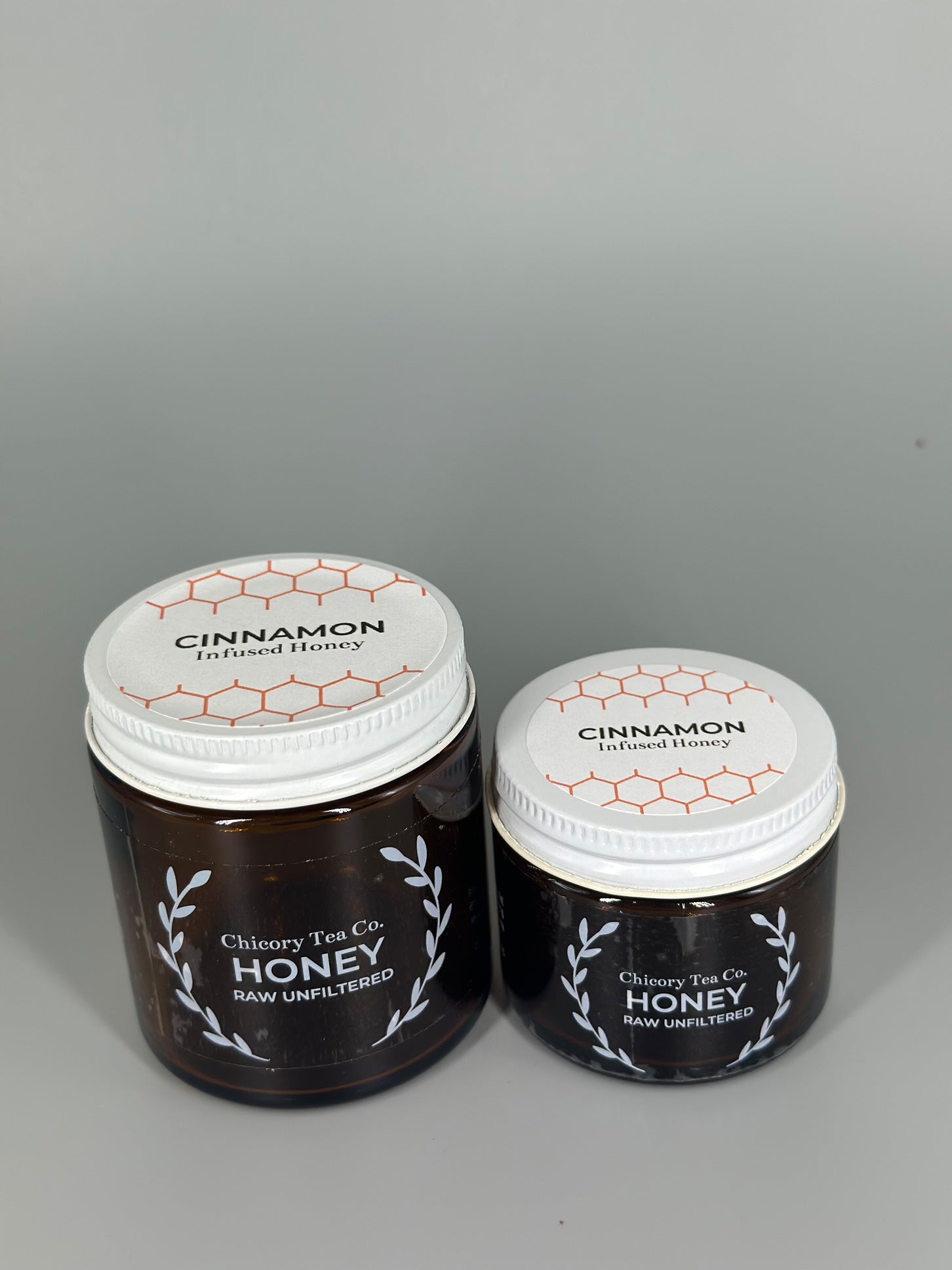Chicory Tea Co.'s Cinnamon Honey 2oz and 4oz jars, view from the front