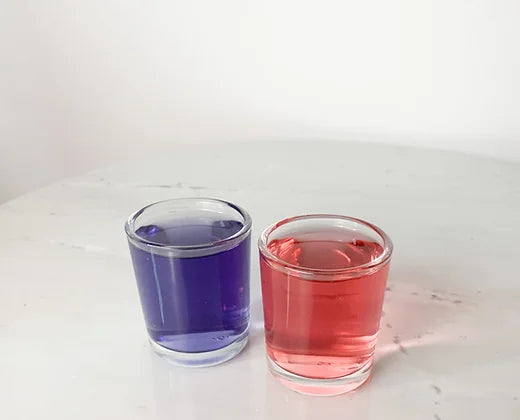 Chicory Tea Co.'s Blueberry Mint & Mango Hibiscus in two separate glasses