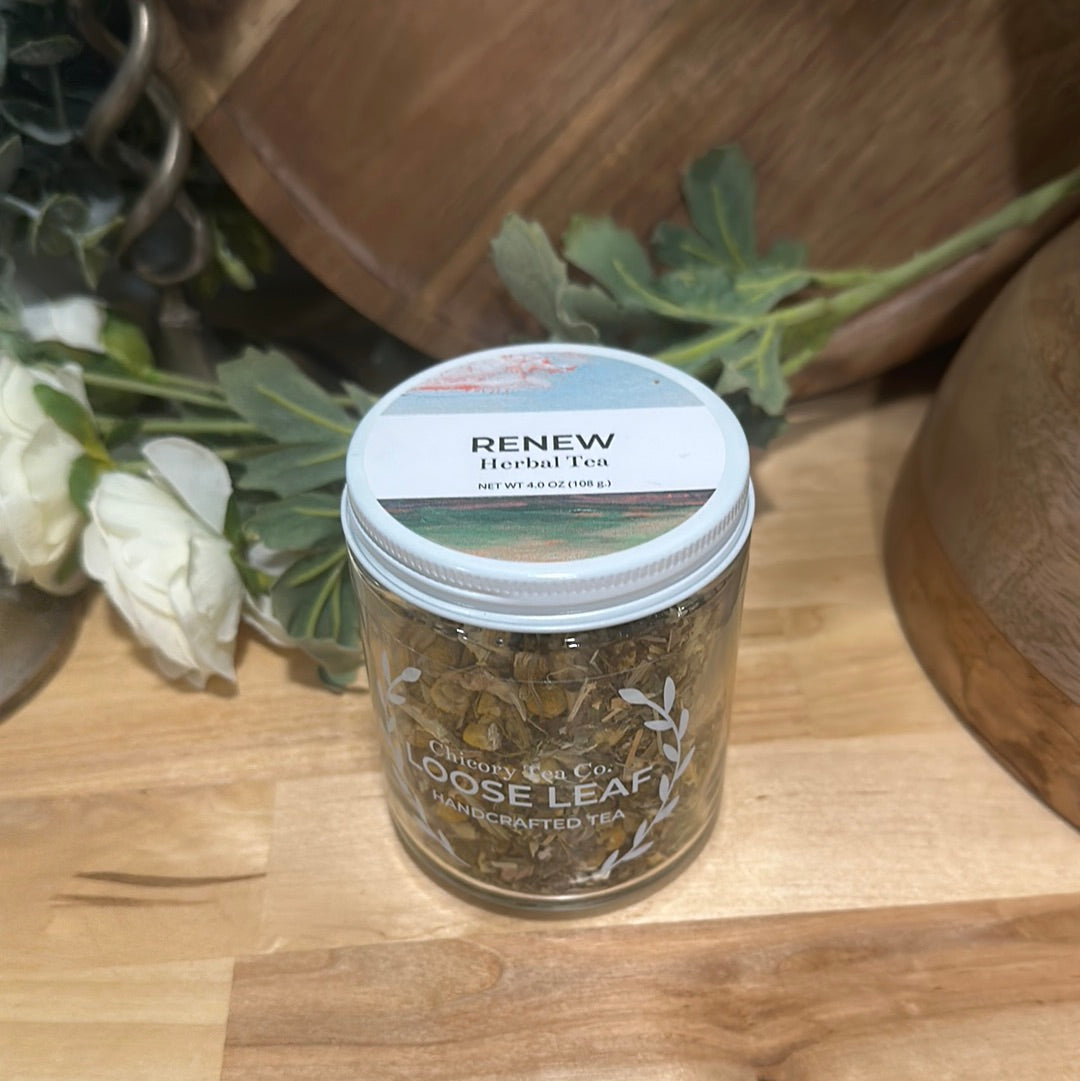 A more artistic version with Chicory Tea Co.'s Renew Herbal Tea in the jar, view from front on a wood floor with flowers and a barrel background