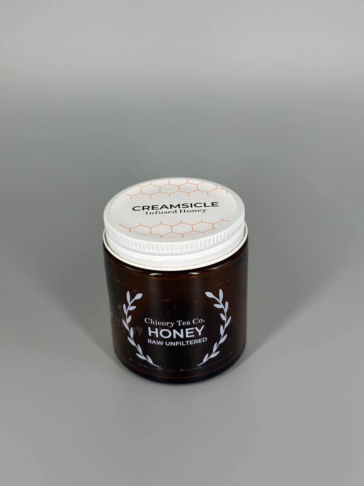 Chicory Tea Co.'s Creamsicle Honey in the jar, view from the front