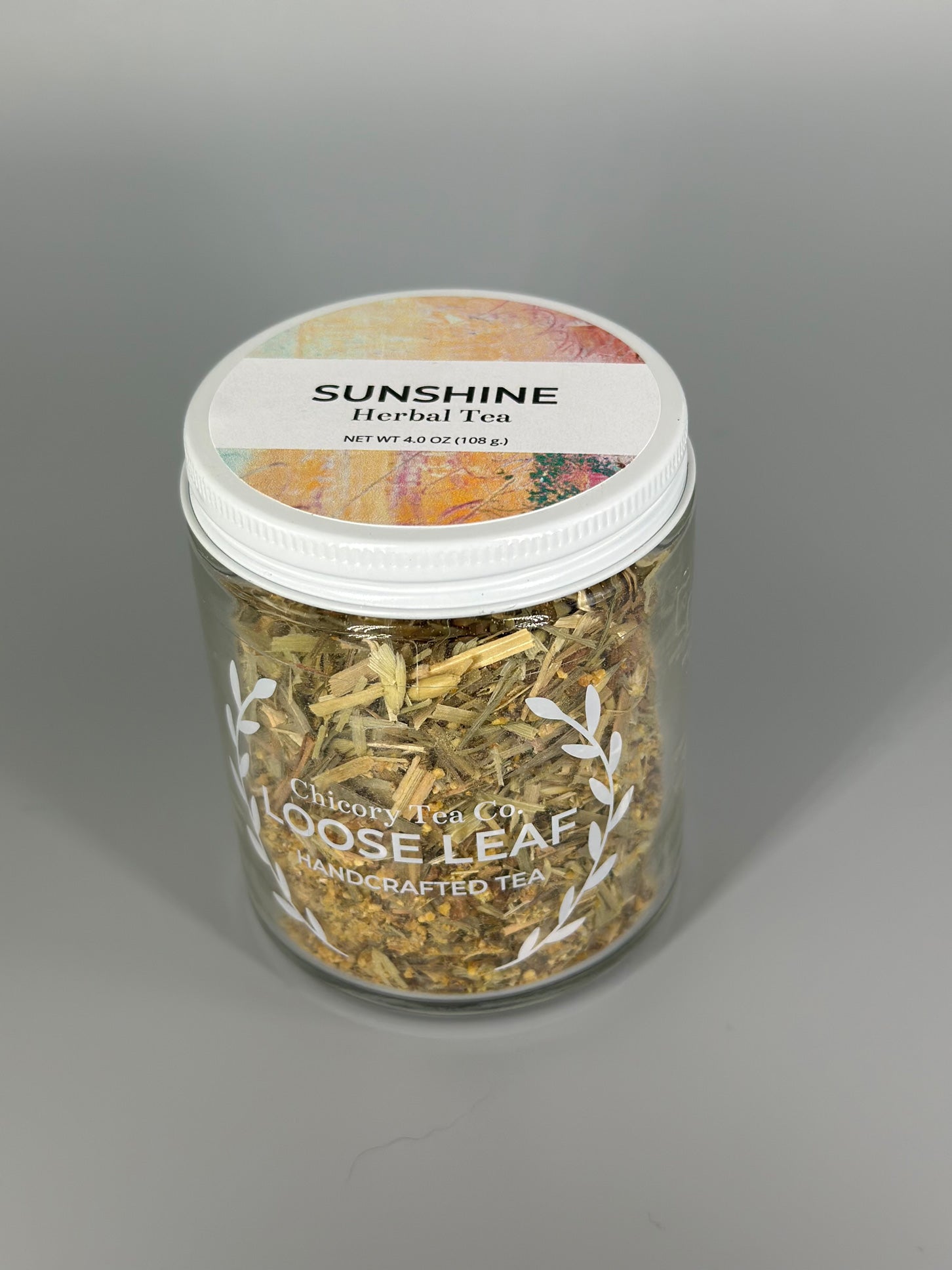 Chicory Tea Co.'s Sunshine Herbal Tea with a view from the front in the jar